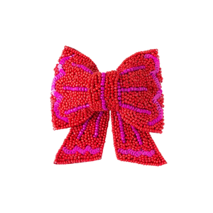 Red and pink beaded bow on a white background