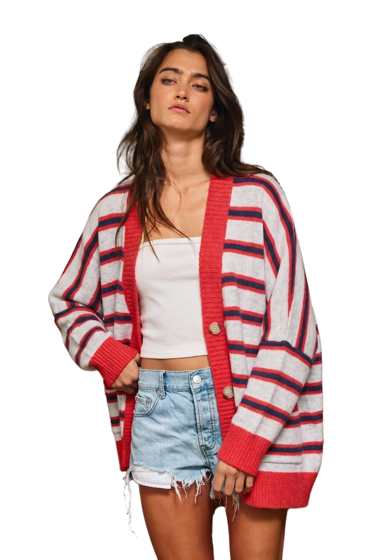A woman modeling a red, white, and navy blue striped knit cardigan over a white crop top and denim shorts